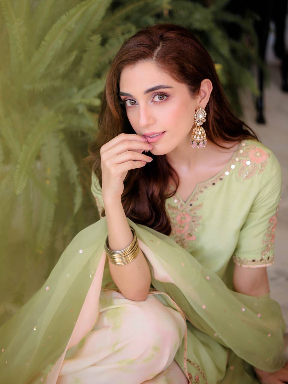 Serene Beauty: A Young Muse Adorned in Lush Green